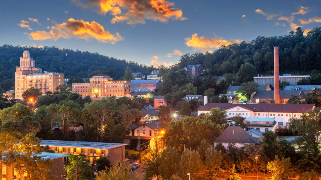 Downtown Hot Springs, Arkansas, at dusk, with historic spa buildings set against the Ouachita Mountains
