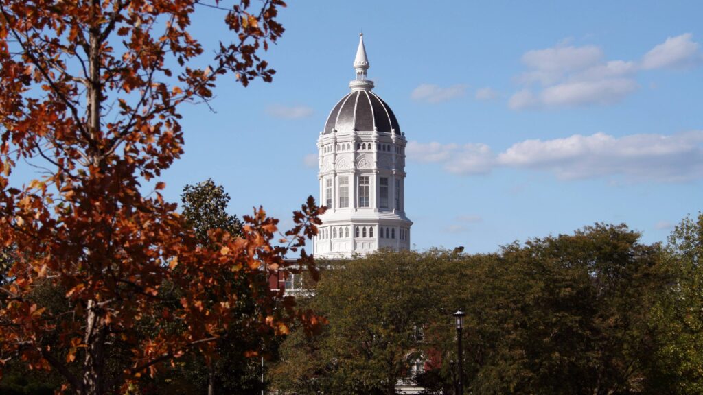 Tower of Jesse Hall on the University of Missouri campus with fall foliage